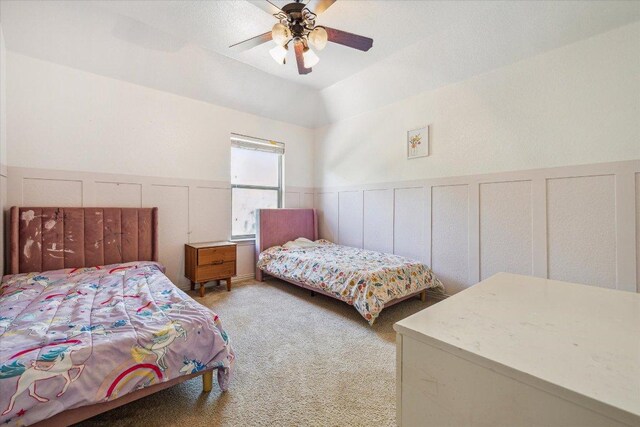 12907 Gordons Hvn, San Antonio, TX 78253 - carpeted bedroom featuring wainscoting, ceiling fan, a decorative wall, and lofted ceiling