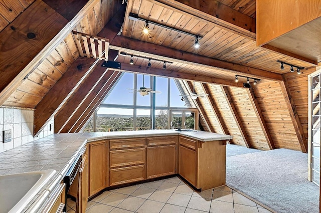 kitchen featuring tile counters, wooden ceiling, and lofted ceiling with beams
