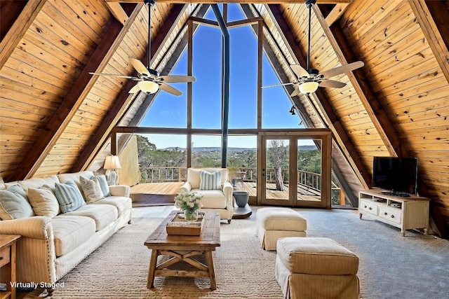 carpeted living room with wooden ceiling, ceiling fan, lofted ceiling with beams, and expansive windows