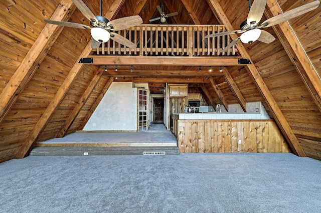interior space with wooden ceiling, vaulted ceiling with beams, visible vents, and carpet floors