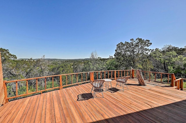wooden deck with a view of trees