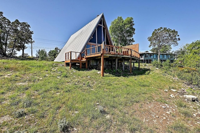 rear view of property featuring a deck