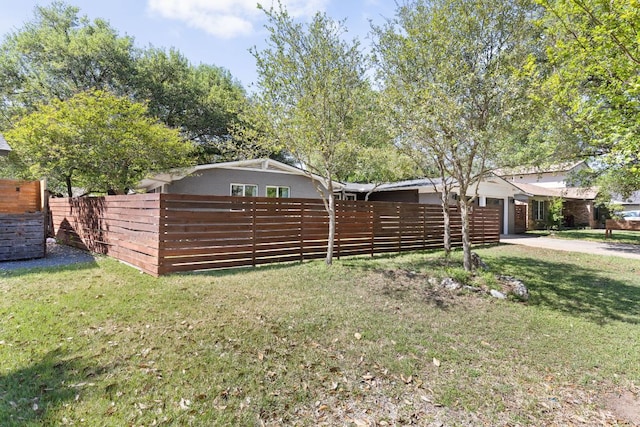 8604 Primrose Ln, Austin, TX 78757 - view of yard featuring a garage and concrete driveway
