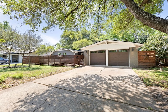 8604 Primrose Ln, Austin, TX 78757 - garage featuring concrete driveway