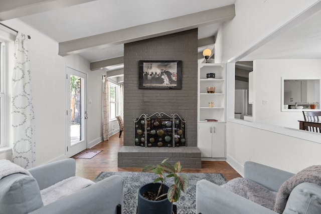 8604 Primrose Ln, Austin, TX 78757 - living room featuring wood finished floors, beam ceiling, and a fireplace