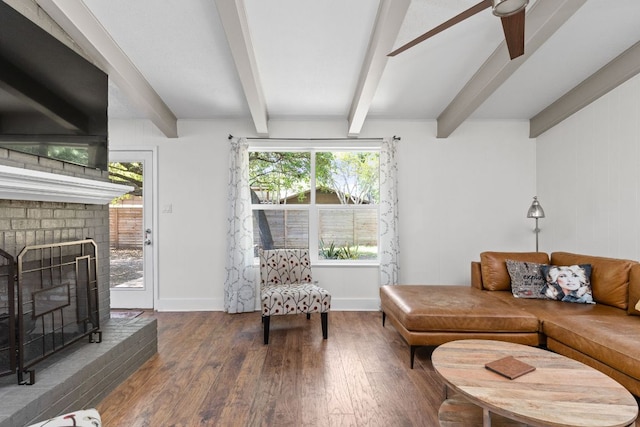 8604 Primrose Ln, Austin, TX 78757 - living area with wood-type flooring, beamed ceiling, plenty of natural light, a ceiling fan, and a brick fireplace