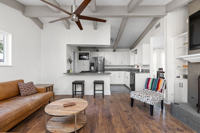 8604 Primrose Ln, Austin, TX 78757 - living area featuring a brick fireplace, a ceiling fan, and dark wood-style flooring