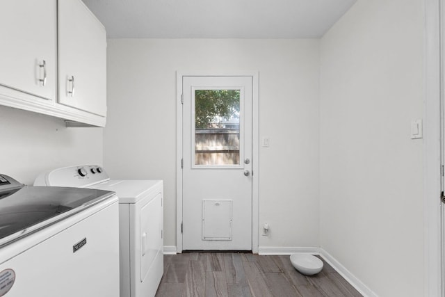 8604 Primrose Ln, Austin, TX 78757 - laundry area featuring cabinet space, independent washer and dryer, and wood finished floors