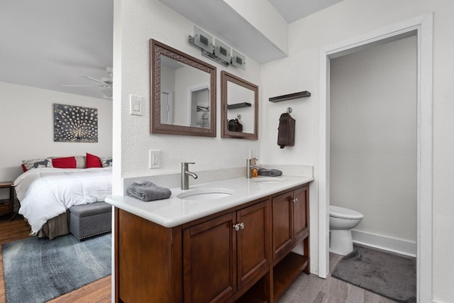8604 Primrose Ln, Austin, TX 78757 - ensuite bathroom featuring vanity, a ceiling fan, and wood finished floors