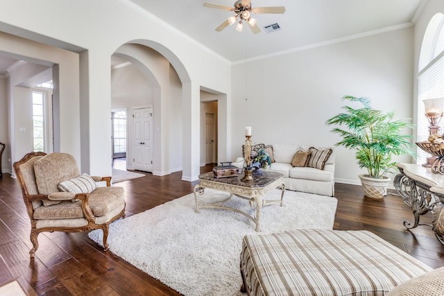 402 Palos Verdes Dr, Lakeway, TX 78734 - living area featuring dark wood-style floors, ceiling fan, crown molding, arched walkways, and baseboards