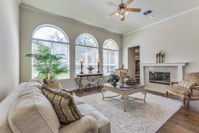 402 Palos Verdes Dr, Lakeway, TX 78734 - living room with a ceiling fan, healthy amount of natural light, dark wood-style floors, ornamental molding, and a tile fireplace