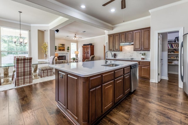 402 Palos Verdes Dr, Lakeway, TX 78734 - kitchen with ceiling fan, appliances with stainless steel finishes, a sink, a fireplace, and under cabinet range hood