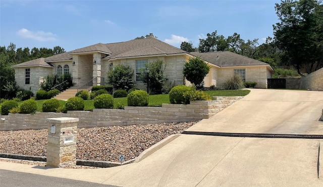 402 Palos Verdes Dr, Lakeway, TX 78734 - view of front of home featuring stone siding, a chimney, and concrete driveway