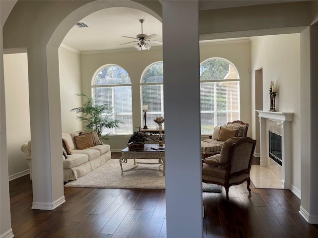 402 Palos Verdes Dr, Lakeway, TX 78734 - living room with a ceiling fan, dark wood-type flooring, a high end fireplace, arched walkways, and crown molding