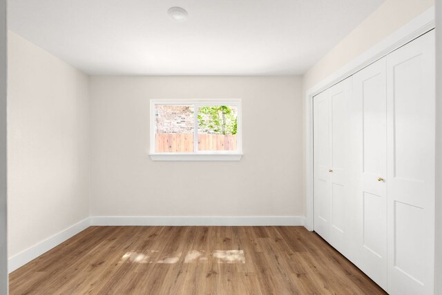 9005 Quail Creek Dr, Austin, TX 78758 - unfurnished bedroom with light wood finished floors and a closet