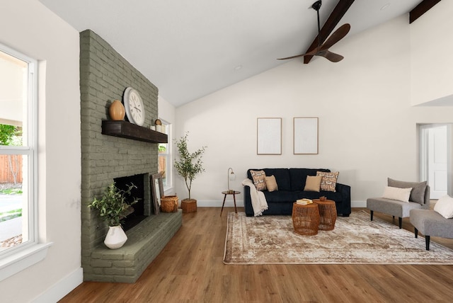 9005 Quail Creek Dr, Austin, TX 78758 - living area featuring a ceiling fan, plenty of natural light, beam ceiling, wood finished floors, and a fireplace