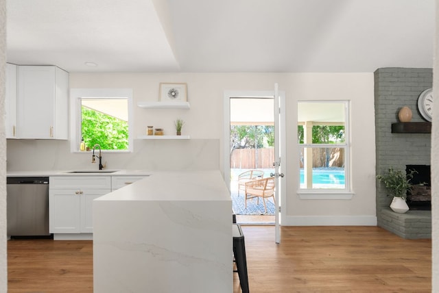 9005 Quail Creek Dr, Austin, TX 78758 - kitchen with dishwasher, white cabinets, and plenty of natural light