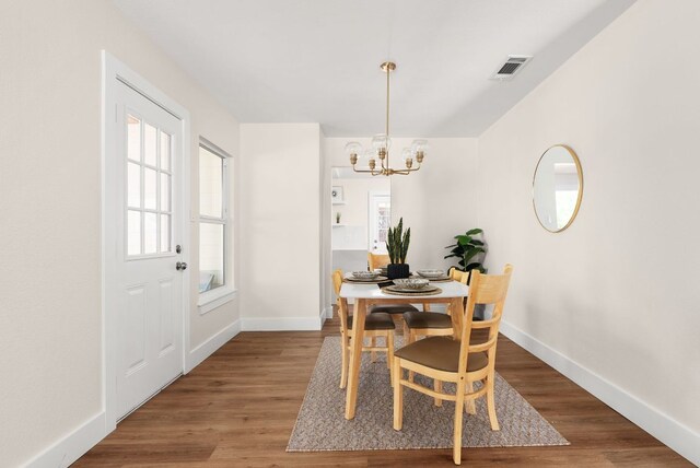 9005 Quail Creek Dr, Austin, TX 78758 - dining area with a chandelier and wood finished floors