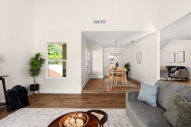 9005 Quail Creek Dr, Austin, TX 78758 - living room with wood finished floors, a chandelier, and a high ceiling