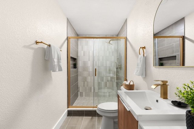 9005 Quail Creek Dr, Austin, TX 78758 - bathroom with vanity, a textured wall, a shower stall, and tile patterned floors
