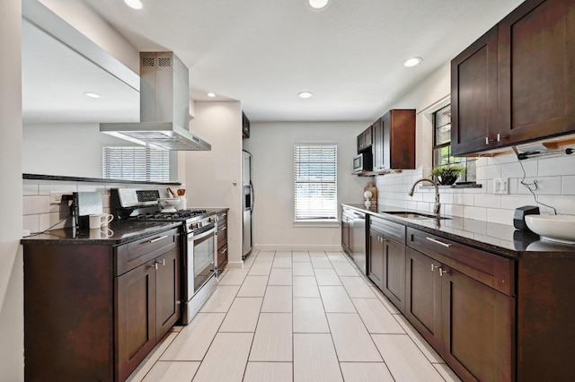 4607 S Forest Dr, Austin, TX 78745 - kitchen with appliances with stainless steel finishes, island range hood, a sink, dark brown cabinetry, and decorative backsplash