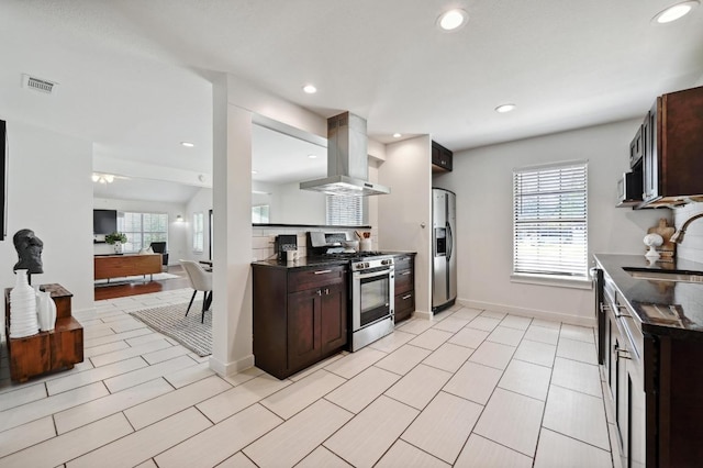 4607 S Forest Dr, Austin, TX 78745 - kitchen with stainless steel appliances, ventilation hood, a sink, dark brown cabinetry, and recessed lighting
