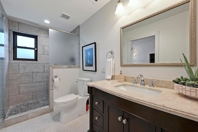 4607 S Forest Dr, Austin, TX 78745 - bathroom with toilet, vanity, tiled shower, and tile patterned floors