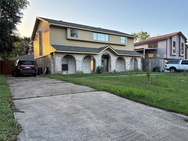 view of front of house featuring a front yard and brick siding