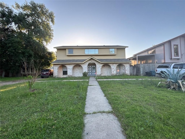 view of front of house with a front lawn and fence
