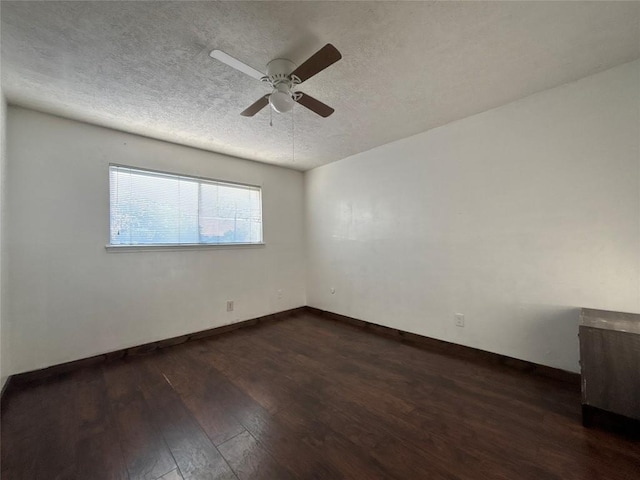 unfurnished room featuring a ceiling fan, a textured ceiling, baseboards, and dark wood-style floors
