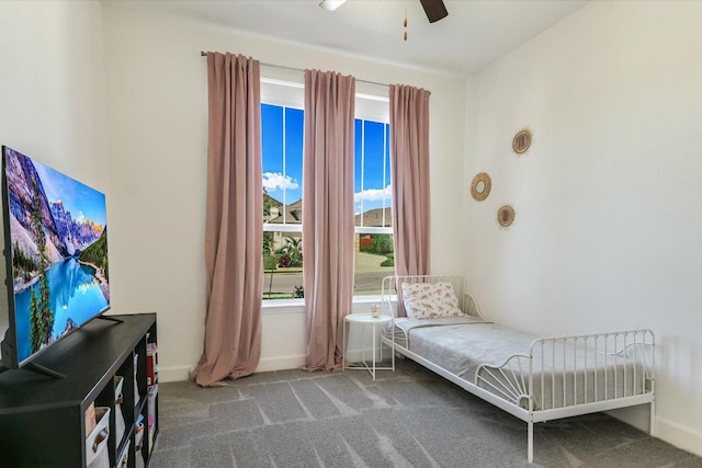 living area with carpet floors, baseboards, and a ceiling fan