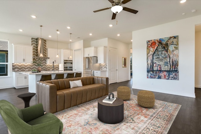 living area featuring recessed lighting, baseboards, ceiling fan, and dark wood-style floors