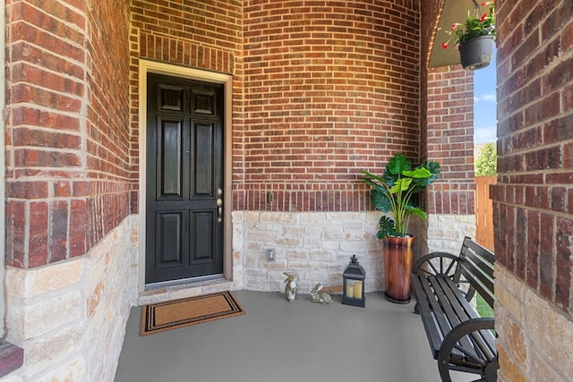 2348 Centennial Loop, Round Rock, TX 78665 - entrance to property with brick siding, stone siding, and a porch