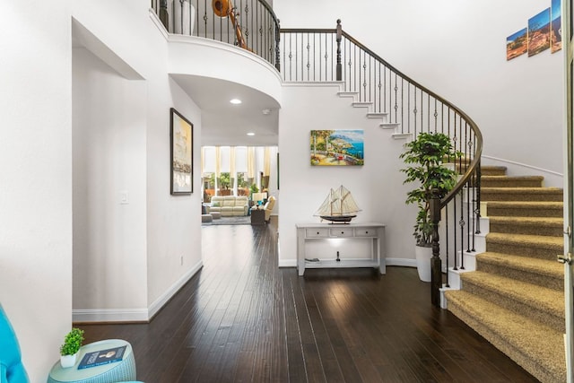 2348 Centennial Loop, Round Rock, TX 78665 - foyer entrance with baseboards, dark wood-type flooring, stairway, and a towering ceiling