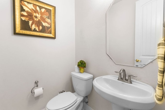 2348 Centennial Loop, Round Rock, TX 78665 - bathroom with a sink, toilet, and baseboards