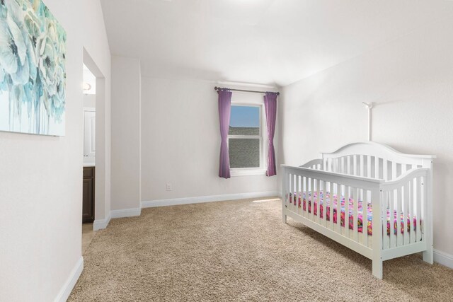 2348 Centennial Loop, Round Rock, TX 78665 - bedroom featuring carpet flooring, baseboards, and a crib