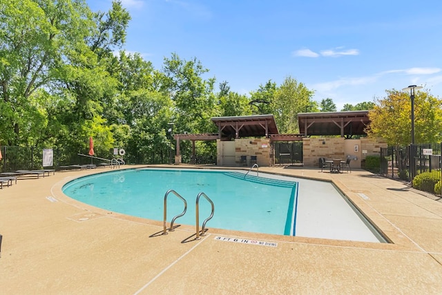 2348 Centennial Loop, Round Rock, TX 78665 - community pool with fence, a patio, and view of scattered trees
