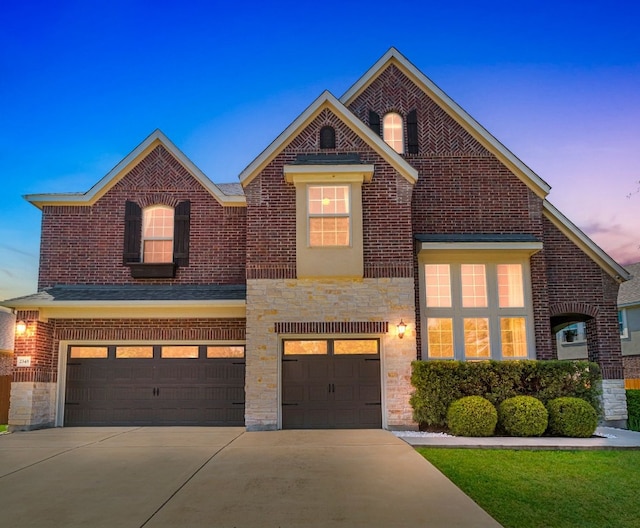 2348 Centennial Loop, Round Rock, TX 78665 - view of front of house featuring a garage, concrete driveway, stone siding, and brick siding