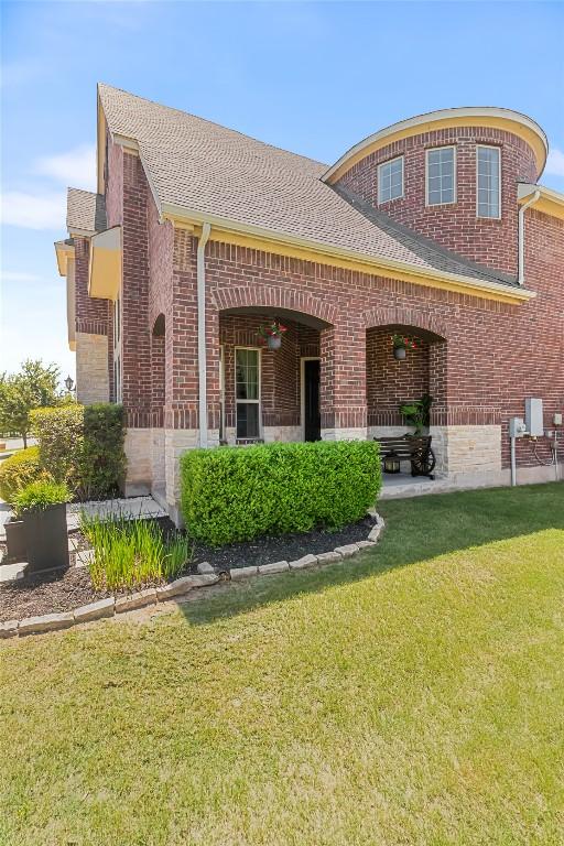 2348 Centennial Loop, Round Rock, TX 78665 - view of front facade with a front yard, brick siding, and a shingled roof