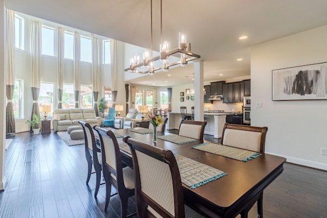 2348 Centennial Loop, Round Rock, TX 78665 - dining area featuring recessed lighting, dark wood-style flooring, baseboards, a chandelier, and a towering ceiling