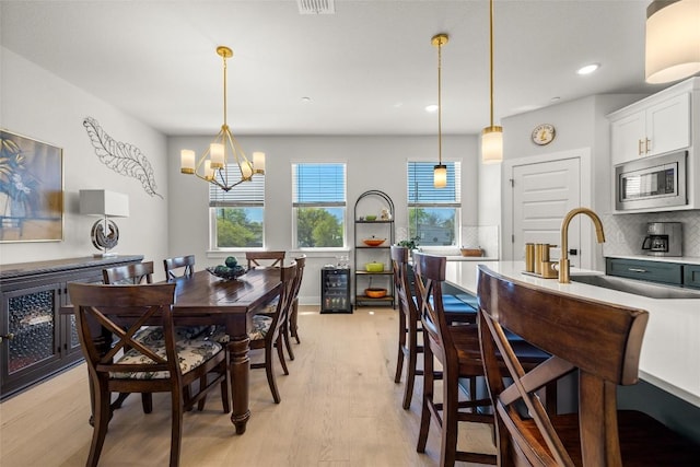 200 W 56th St Unit 4102, Austin, TX 78751 - dining room with a chandelier, light wood-style floors, recessed lighting, and beverage cooler