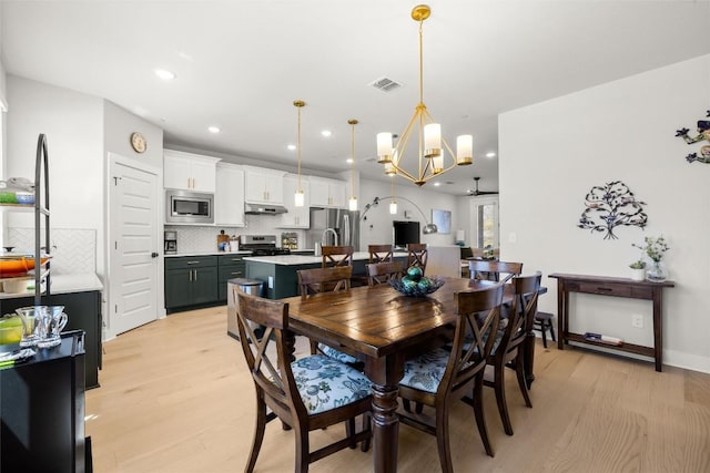 200 W 56th St Unit 4102, Austin, TX 78751 - dining space with light wood-style flooring, a chandelier, and recessed lighting