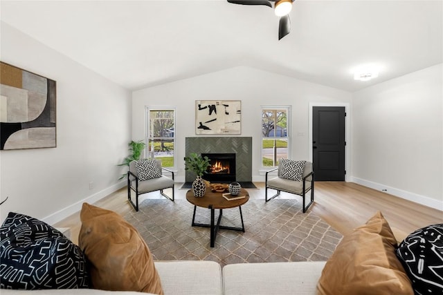 2702 Irish Bend Dr, Austin, TX 78745 - living area featuring wood finished floors, plenty of natural light, vaulted ceiling, and a fireplace