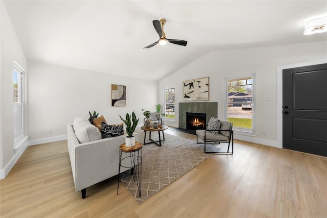 2702 Irish Bend Dr, Austin, TX 78745 - living area featuring baseboards, light wood-type flooring, vaulted ceiling, a fireplace, and ceiling fan