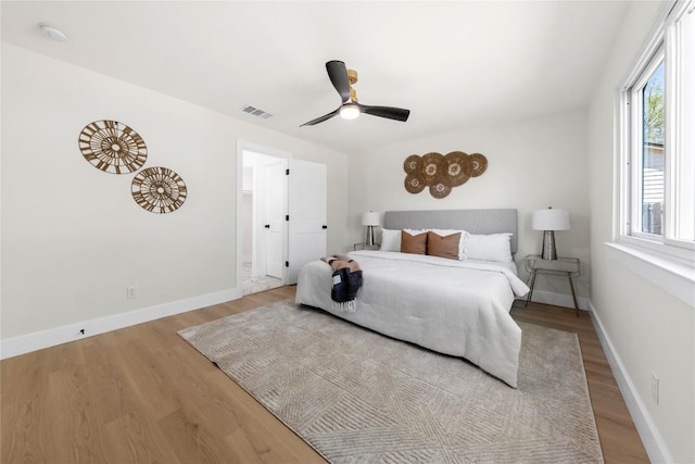 2702 Irish Bend Dr, Austin, TX 78745 - bedroom featuring visible vents, baseboards, a ceiling fan, and wood finished floors
