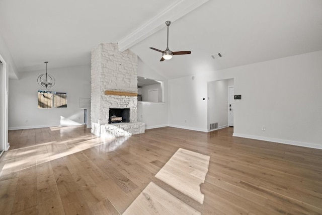 6107 Amber Pass, Austin, TX 78745 - unfurnished living room with wood finished floors, a ceiling fan, a fireplace, baseboards, and a chandelier