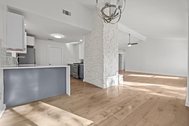 6107 Amber Pass, Austin, TX 78745 - kitchen featuring stainless steel gas range oven, fridge, light wood-type flooring, and white cabinetry