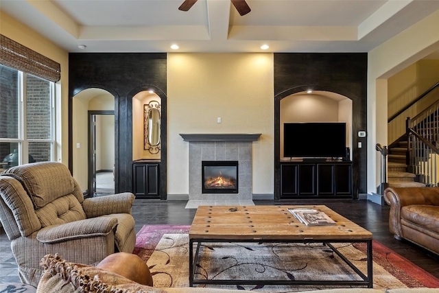 5612 Cherokee Draw Rd, Austin, TX 78738 - living room featuring arched walkways, a ceiling fan, recessed lighting, wood finished floors, and a tiled fireplace