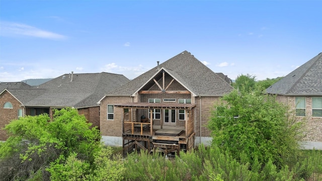 5612 Cherokee Draw Rd, Austin, TX 78738 - rear view of house featuring brick siding, a deck, and a shingled roof