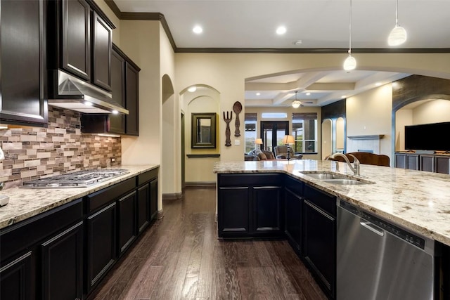 5612 Cherokee Draw Rd, Austin, TX 78738 - kitchen with stainless steel appliances, open floor plan, crown molding, light stone countertops, and backsplash